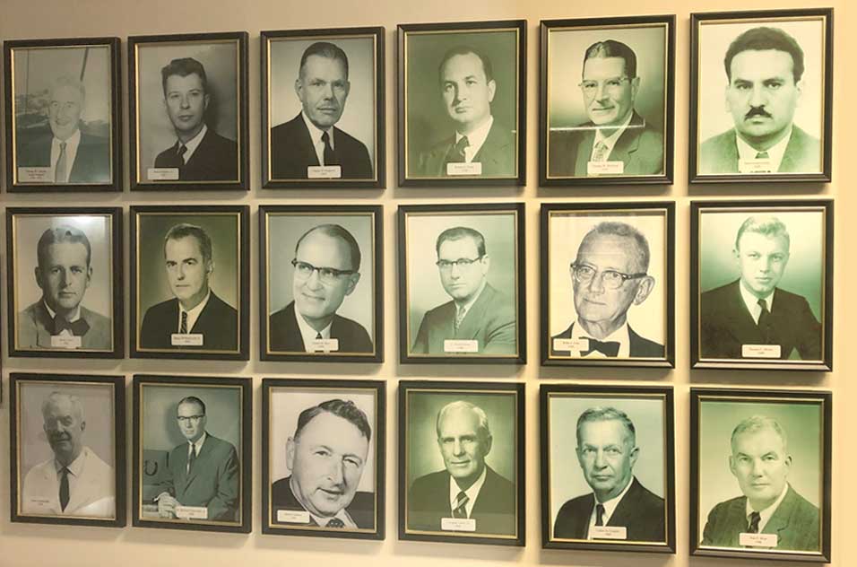 Pictures on a wall of former surgical fellows