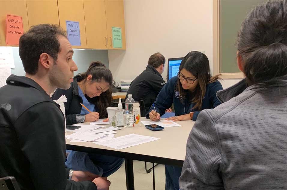 Surgical fellows working and discussing at a table