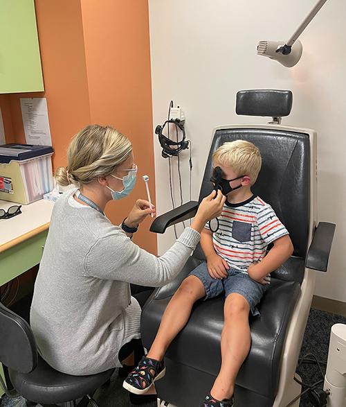 Clinician giving a child an eye exam