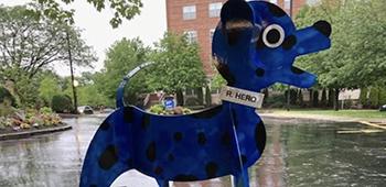 Sculpture of a blue dog in front of the BCH Waltham Campus