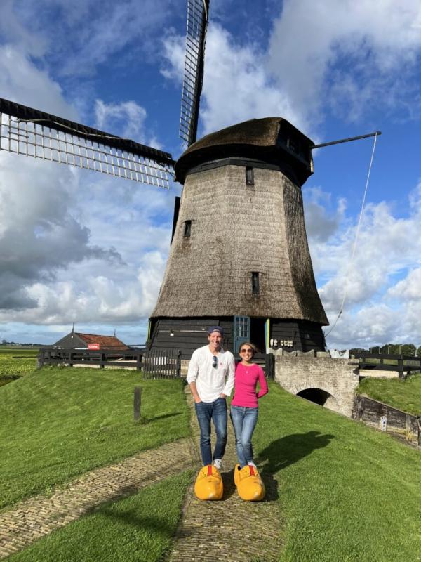 Evalynn Vasquez and partner in front of a windmill