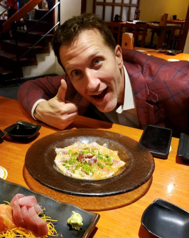 Ahmet Uluer smiling with food
