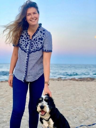 Jaclyn Davis on the beach with a dog