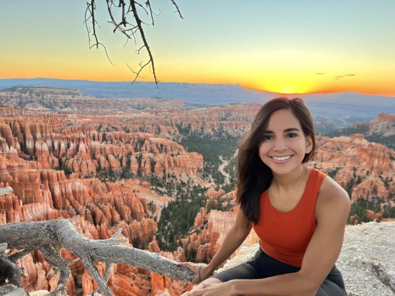 Karin Plaza Lazo in front of a mountain landscape at sunset