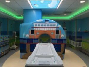 Image of an MRI scanner that is painted to look like a boat. 